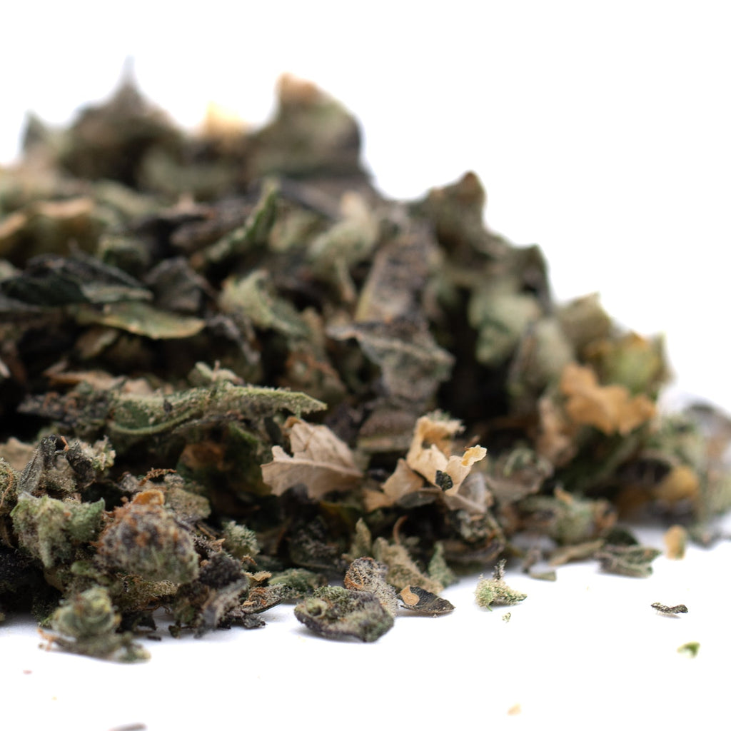 Dried green herbs of Butter OG’s Indoor Trim, ideal for THCA trim enthusiasts